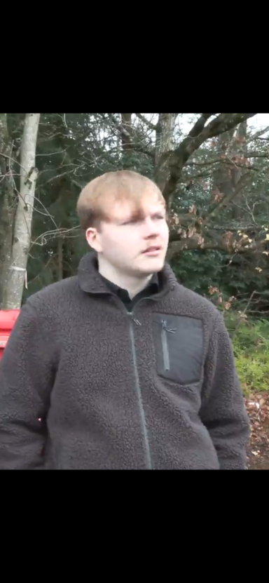 Harry Boyle Young man with light brown hair wearing a dark jacket, standing outdoors.